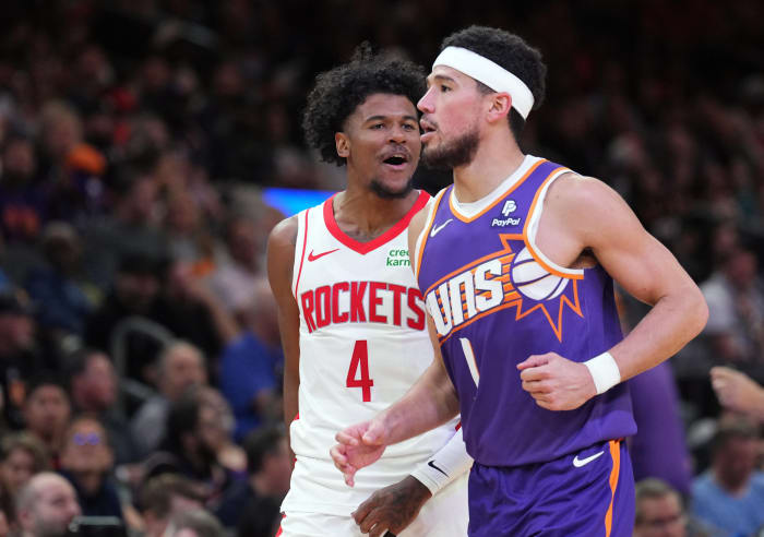 Rockets guard Jalen Green (4) reacts in front of Phoenix Suns guard Devin Booker (1) during the second half at Footprint Center.